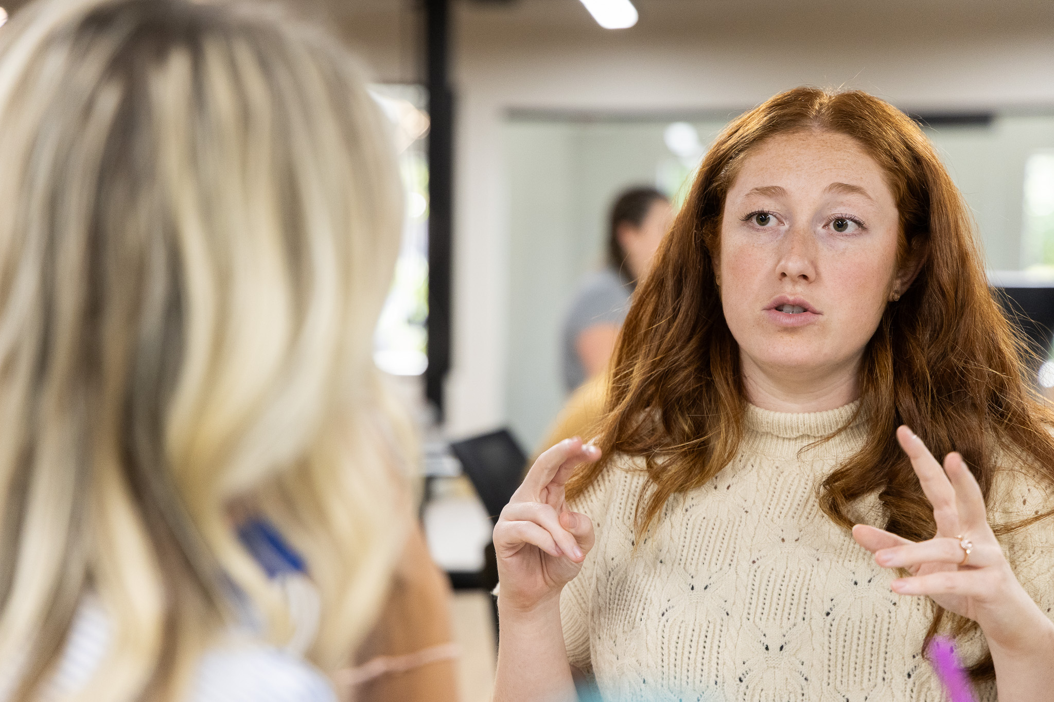 Five Door Media team members in a working conversation at the office